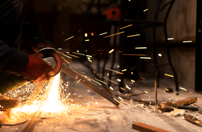 man-using-angle-grinder-with-sparks